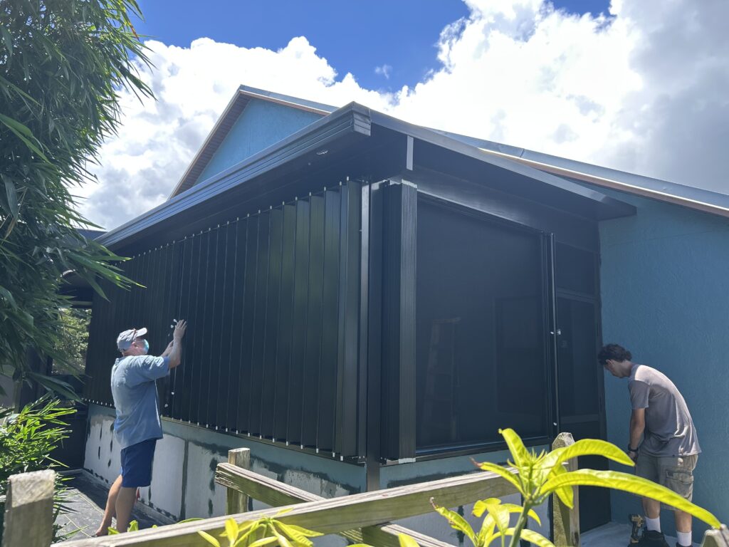 Accordion hurricane shutters installation in Melbourne, Florida during Tropical Storm Erin 2025
