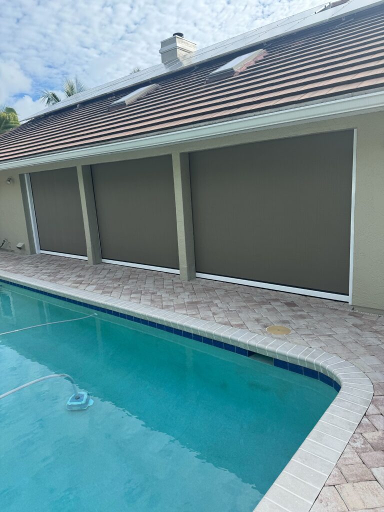 Magnatrack Progressive Roll Screen installed on a patio in Viera, Florida, providing shade, privacy, and insect protection.