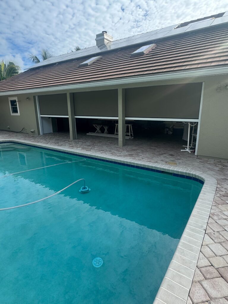 Magnatrack Progressive Roll Screen halfway open on a Viera, Florida patio, showing adjustable shade and airflow control.