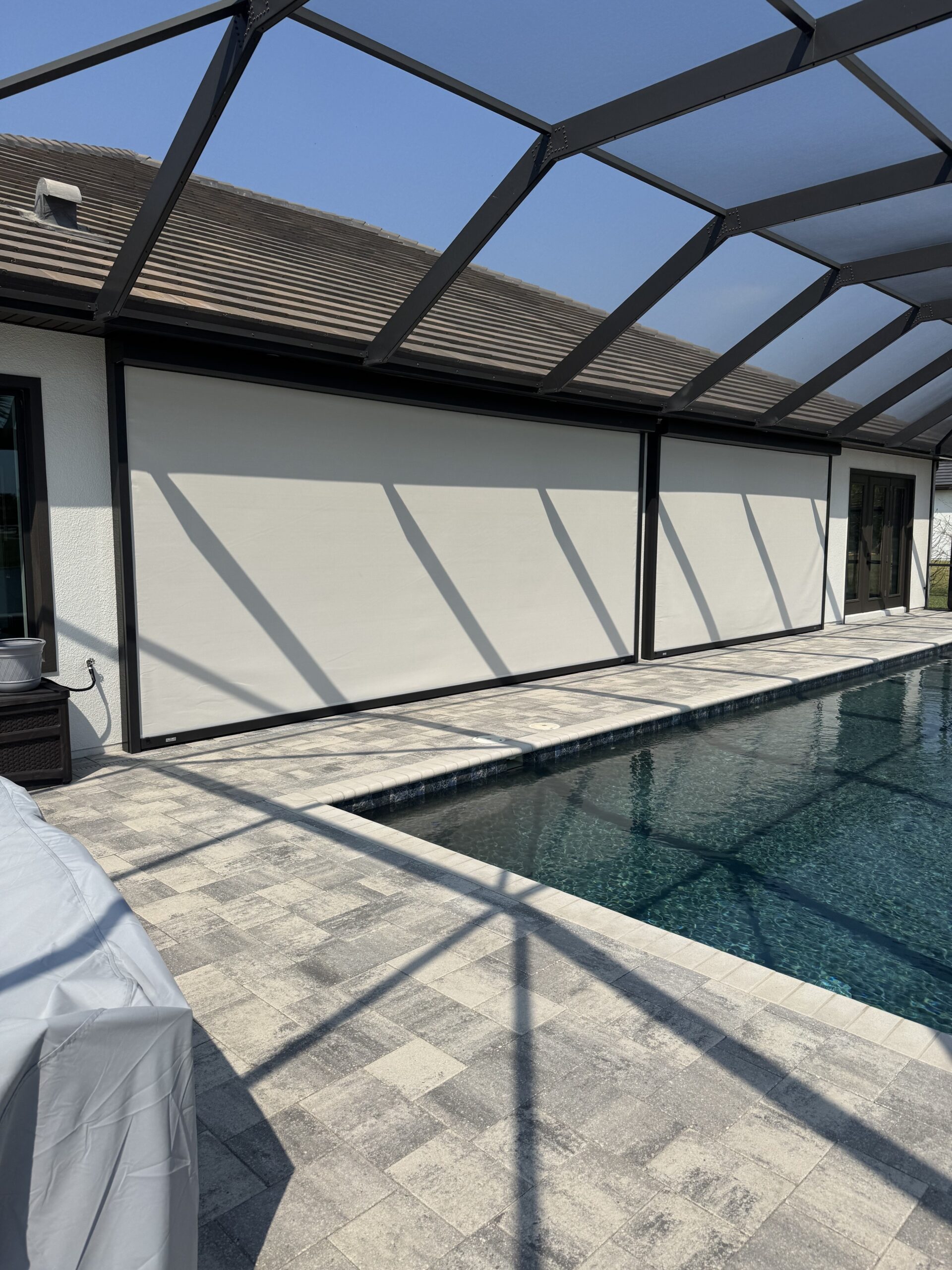 White hurricane patio screen installed in Viera Florida MagnaTrack Defender lanai protection