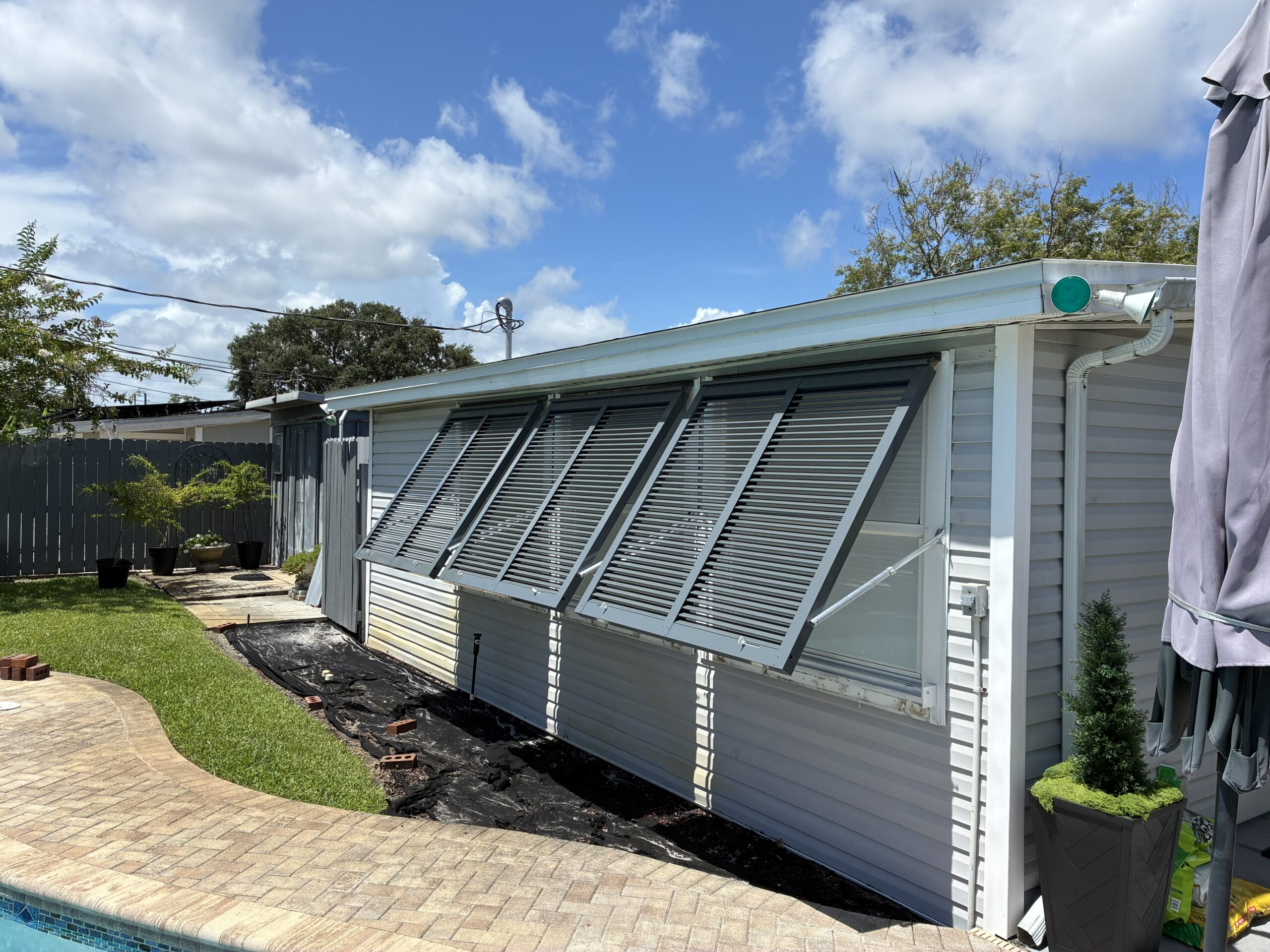 Custom Bahama hurricane shutters installed on a home in Melbourne Florida by Affordable Glass Protection