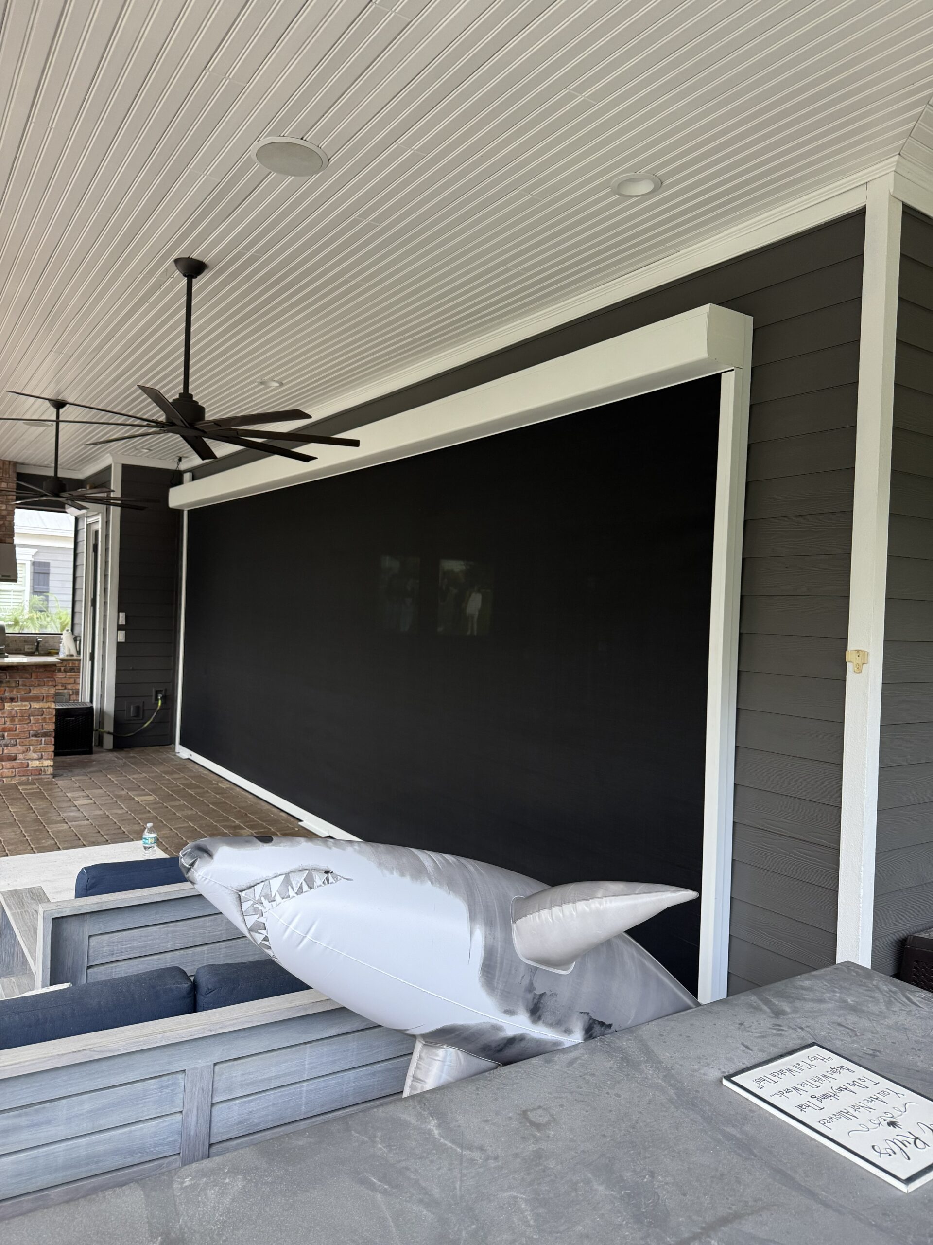 Custom black patio screen with white trim installed in Melbourne FL by Affordable Glass Protection