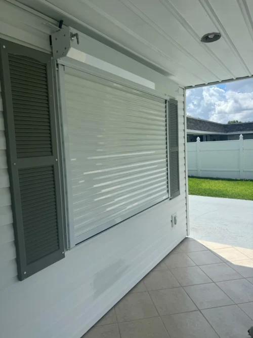 Roll Down Metal Shutters Ivory White — installed by Affordable Glass Protection