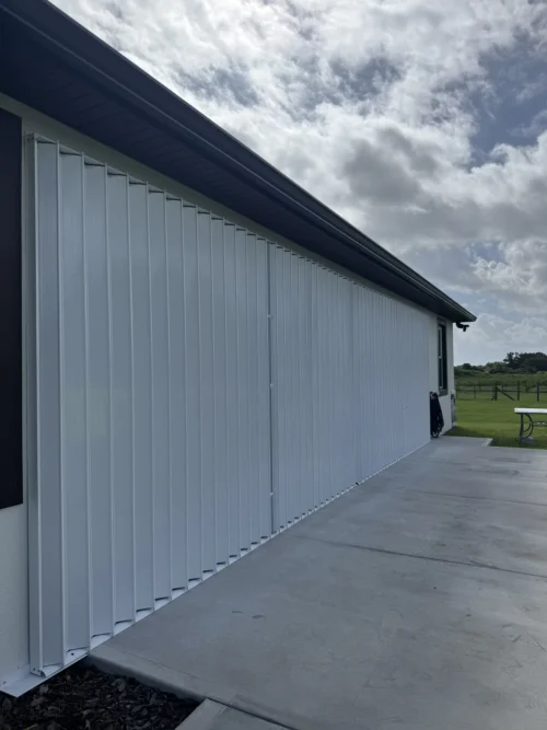 White Accordion Shutters Installed Mims Florida — installed by Affordable Glass Protection